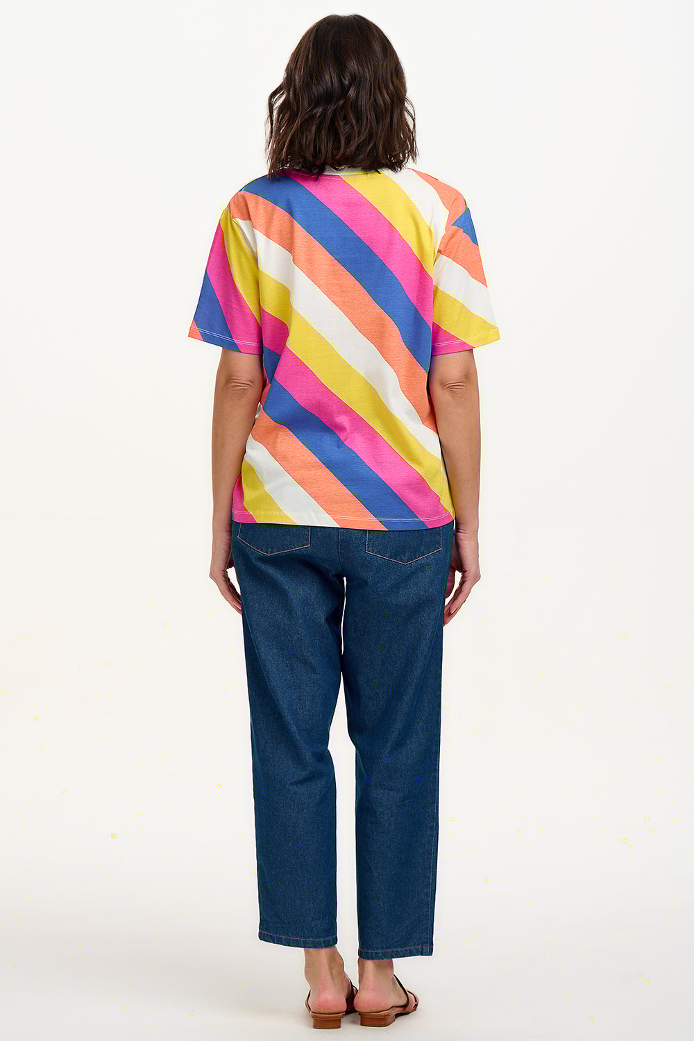 A model wearing a multicolored striped relaxed fit t-shirt with short sleeves and a round neckline.