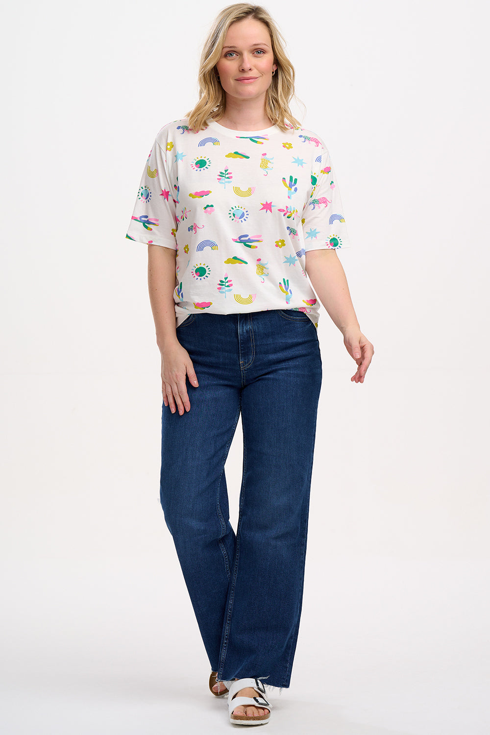 An off-white Kinsley Relaxed T-shirt with a round neck and short sleeves, featuring a colorful floral and animal pattern.