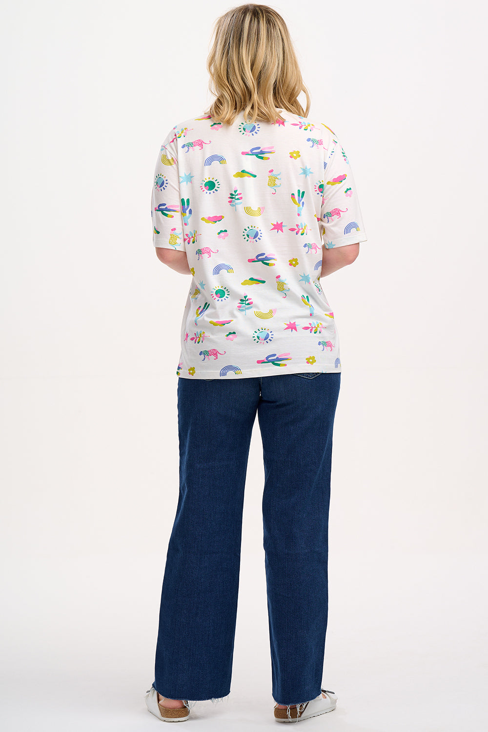 An off-white Kinsley Relaxed T-shirt with a round neck and short sleeves, featuring a colorful floral and animal pattern.