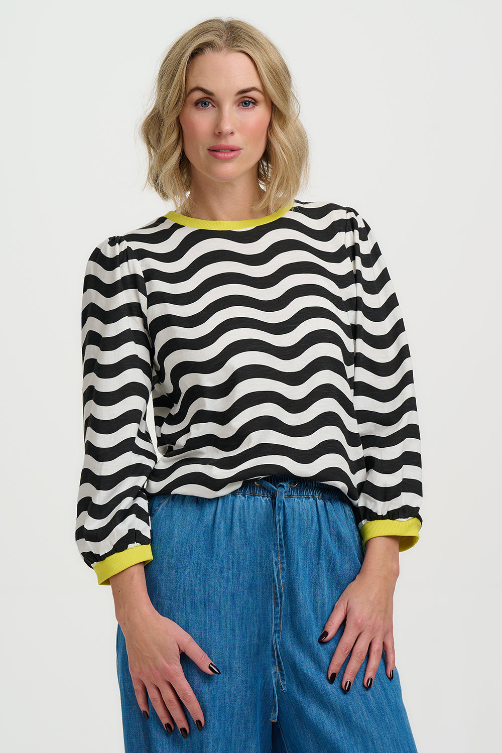 Model wearing Black and white striped sweater with yellow accents on a white background