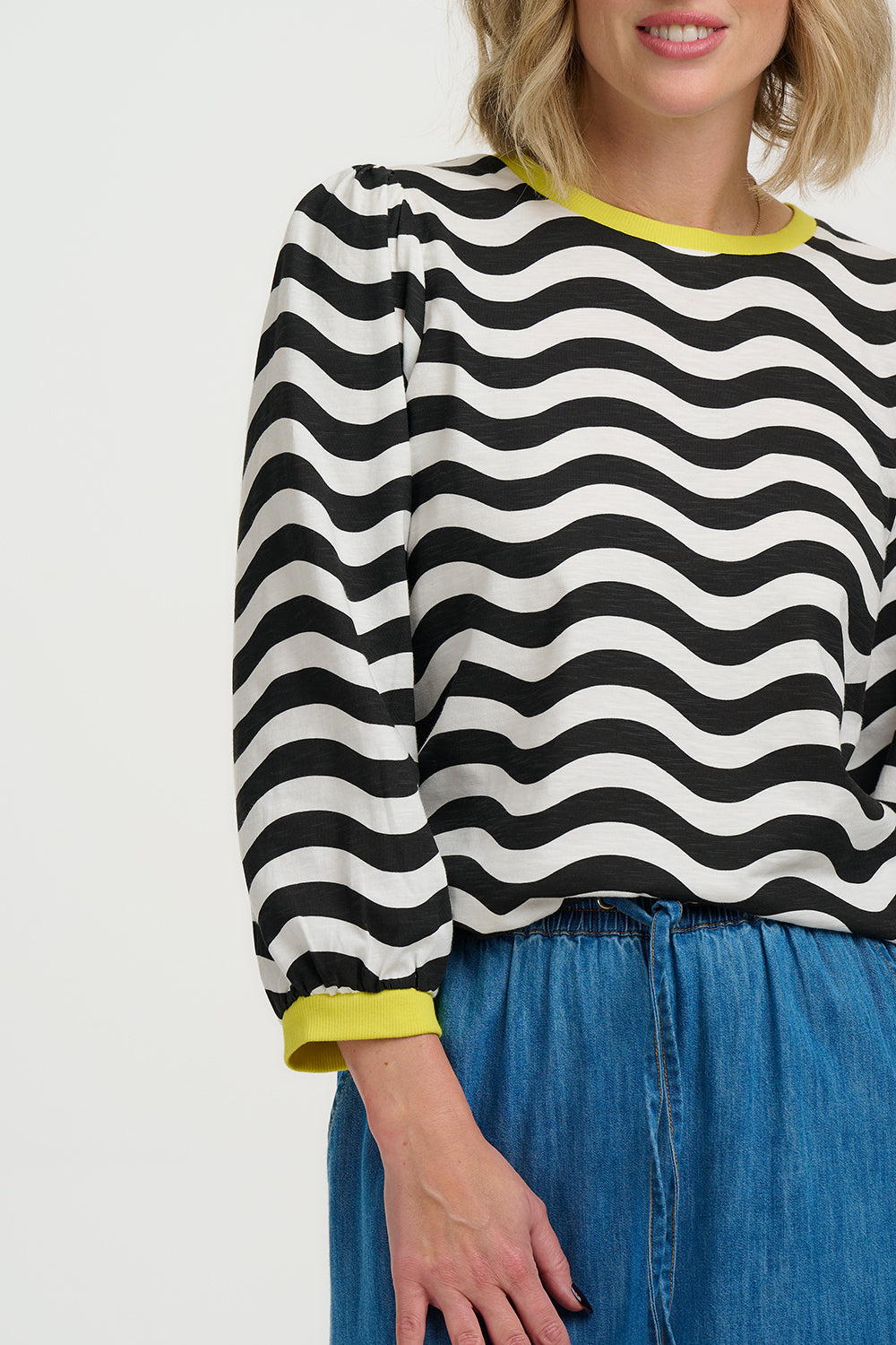 Model wearing Black and white striped sweater with yellow accents on a white background