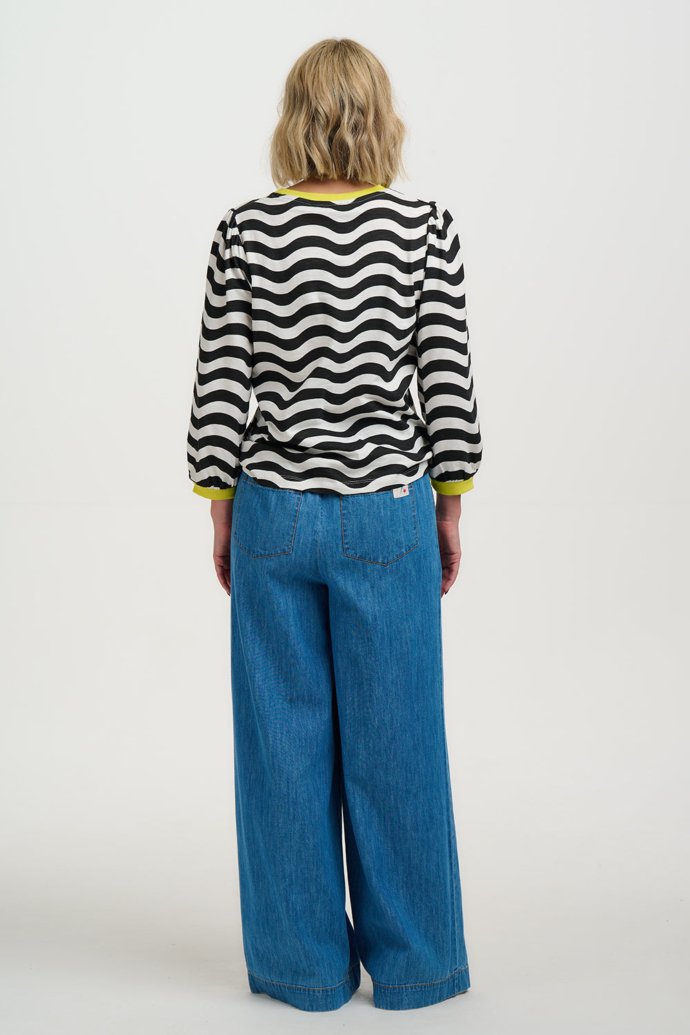 Model wearing Black and white striped sweater with yellow accents on a white background