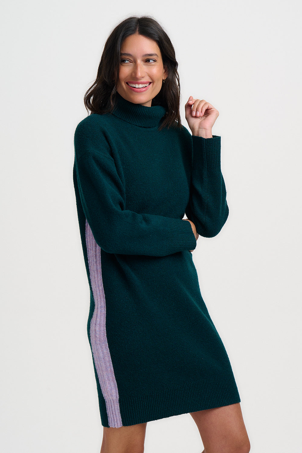 Woman wearing a green dress with a pink stripe on a white background
