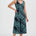 Woman wearing a green and black patterned dress on a white background