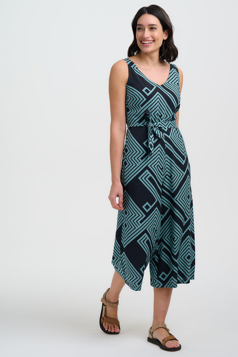 Woman wearing a sleeveless dress with a geometric pattern on a white background