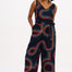 A black jumpsuit with a geometric pattern featuring colorful lines.