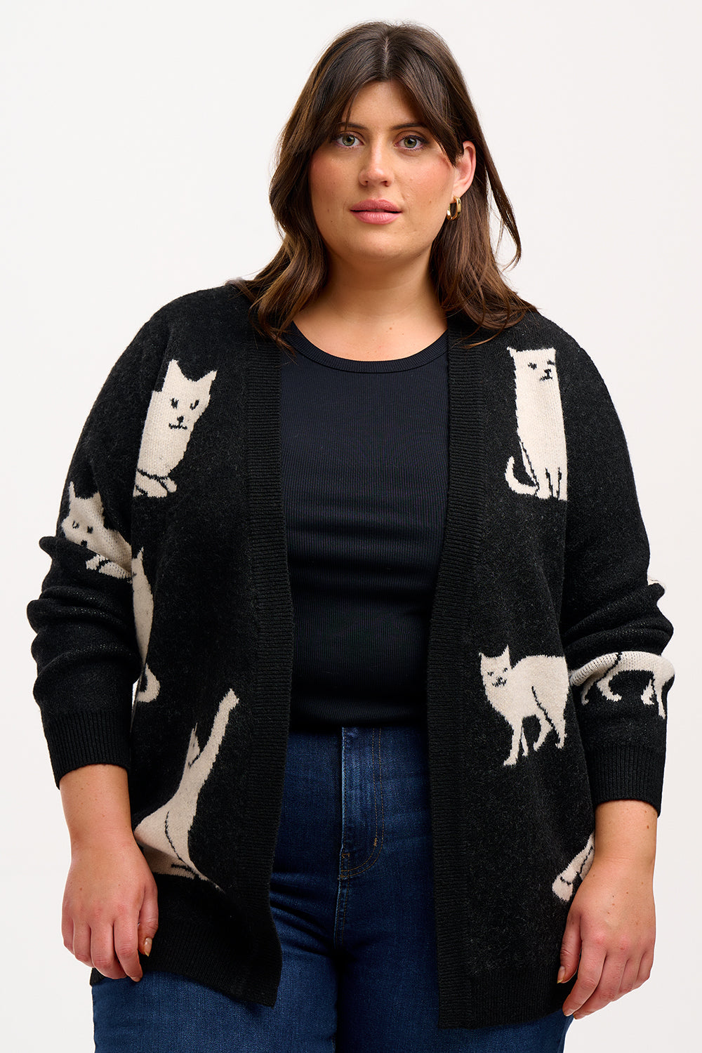 Woman wearing a black cardigan with cat patterns.