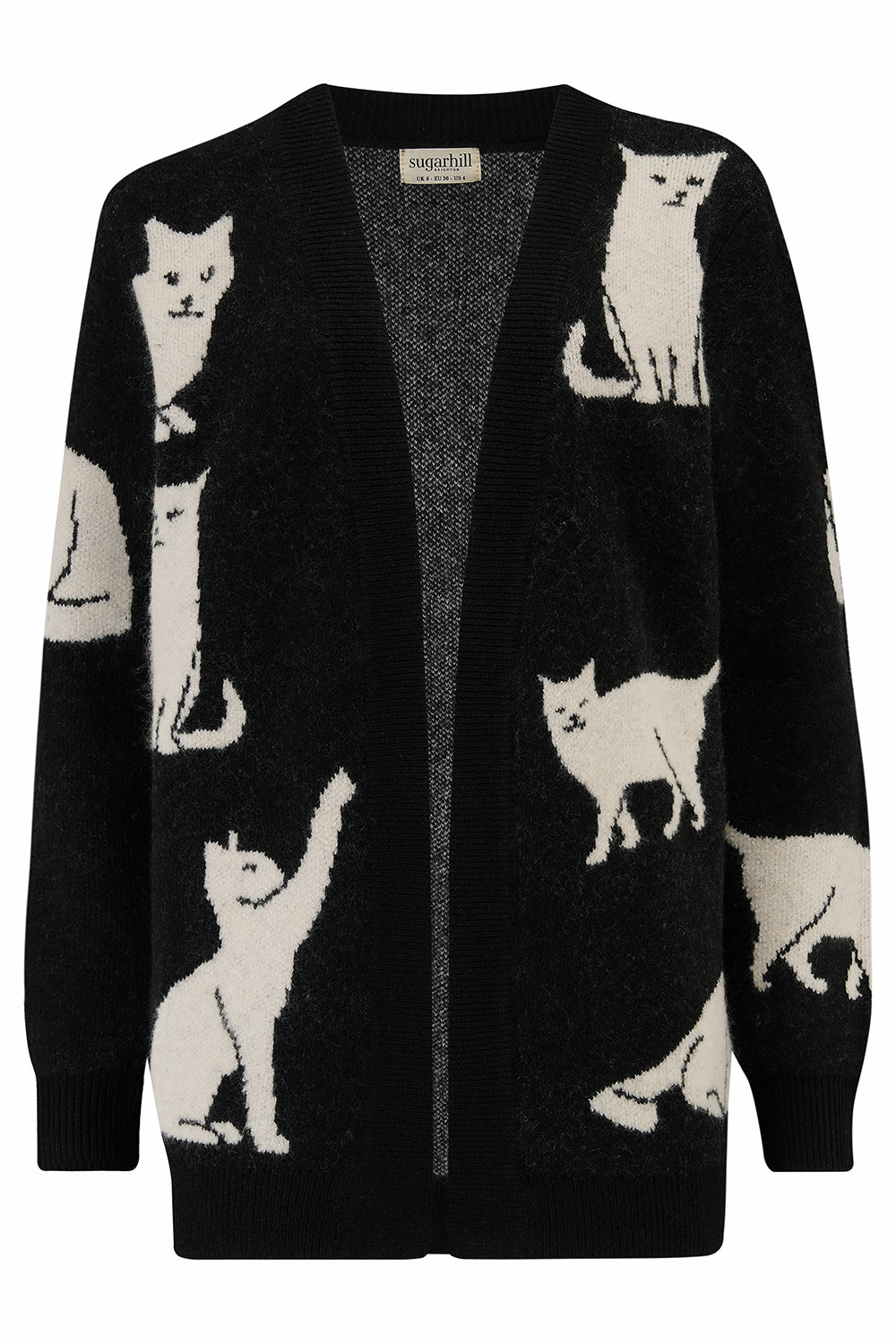 Woman wearing a black cardigan with cat patterns.