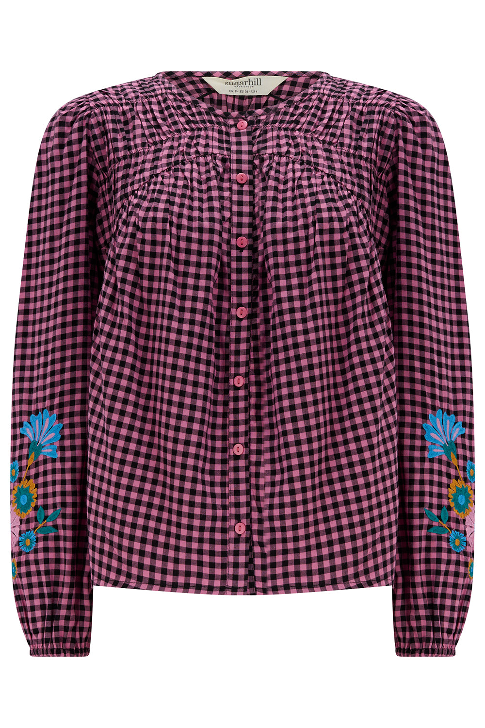 Pink and black checkered shirt with floral embroidery on sleeves against a white background