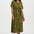 Woman wearing a green patterned dress on a white background