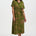 Woman wearing a green patterned dress on a white background