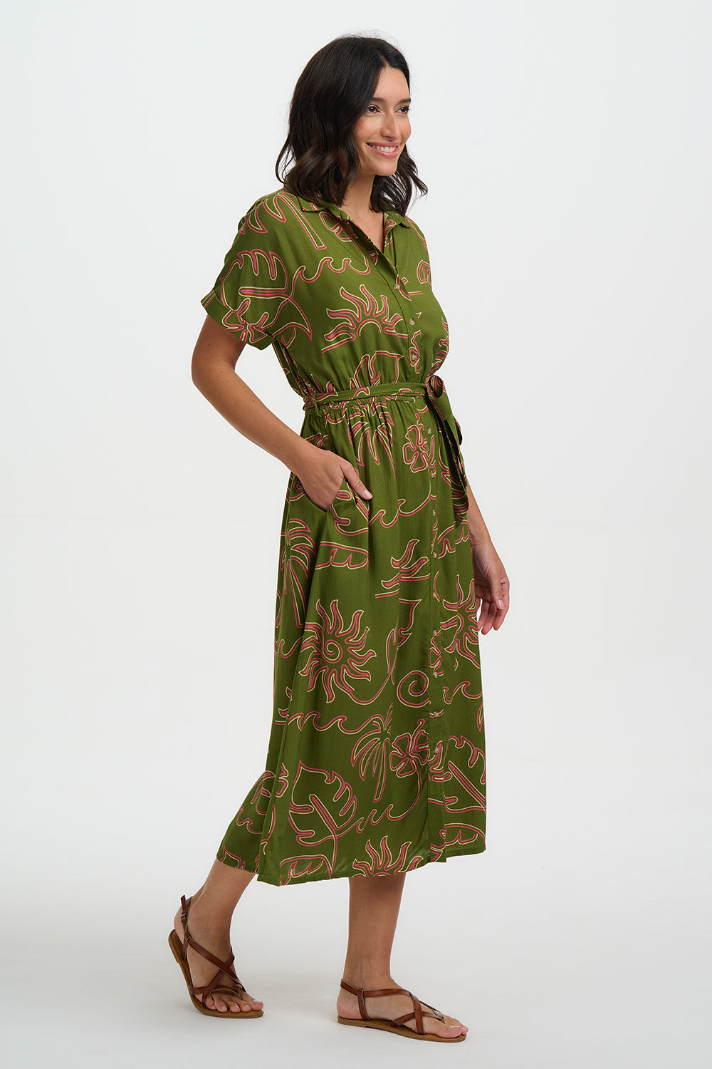 Woman wearing a green dress with a pattern on a white background
