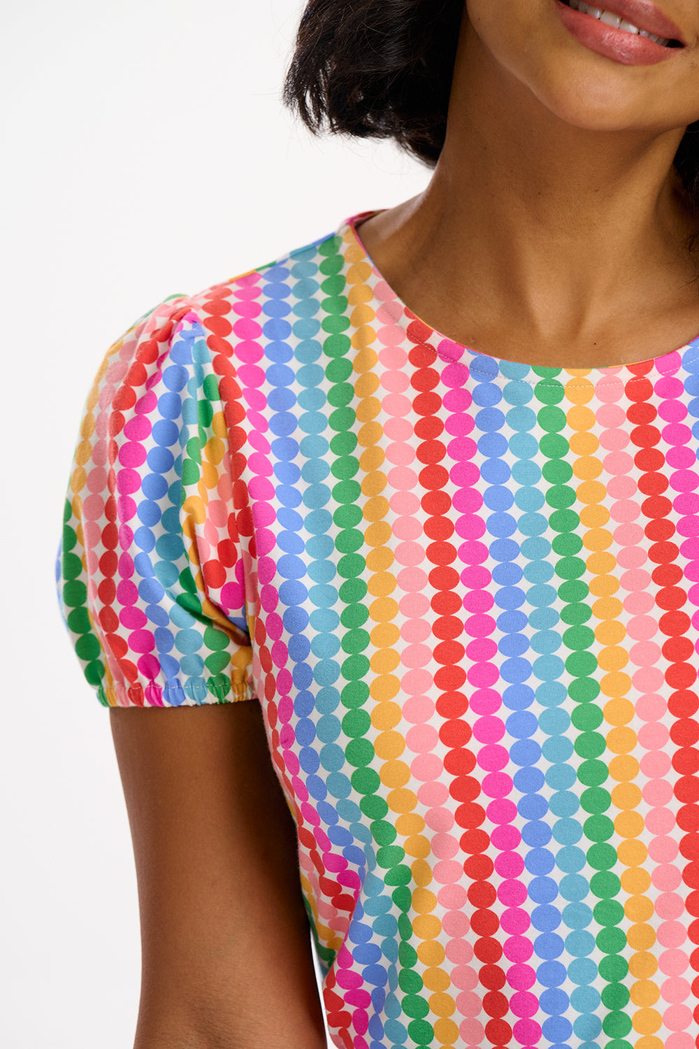 A multicolored, rainbow-striped jersey top with short sleeves.