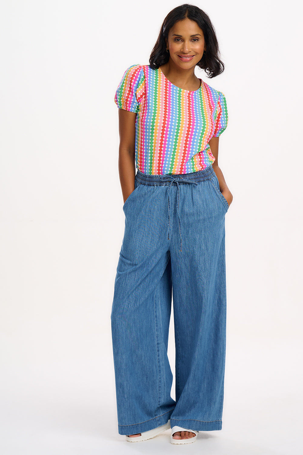 A multicolored, rainbow-striped jersey top with short sleeves.