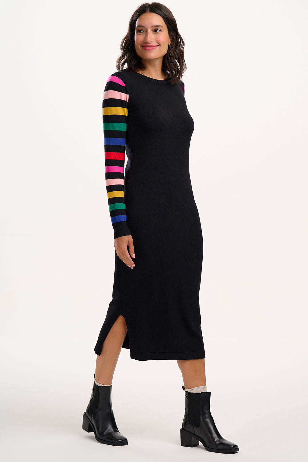 Woman wearing a black dress with colorful sleeves on a white background