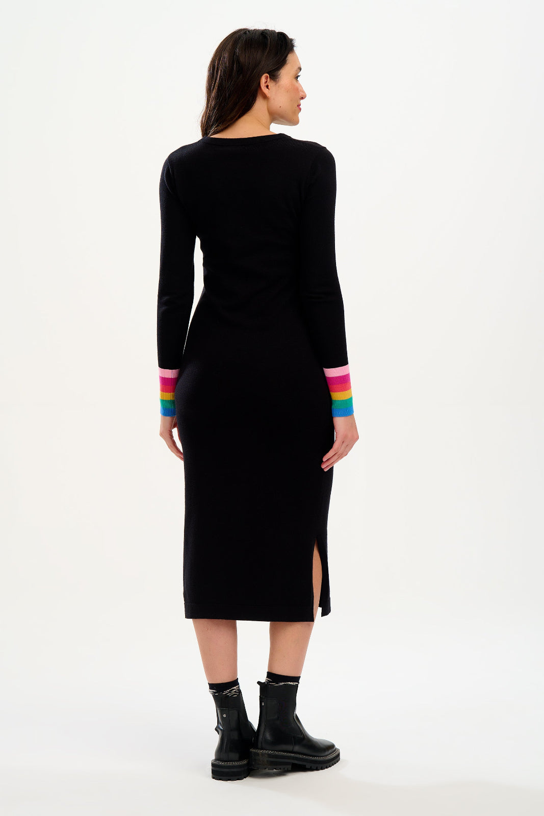 Black dress with rainbow cuffs worn by a model on a white background