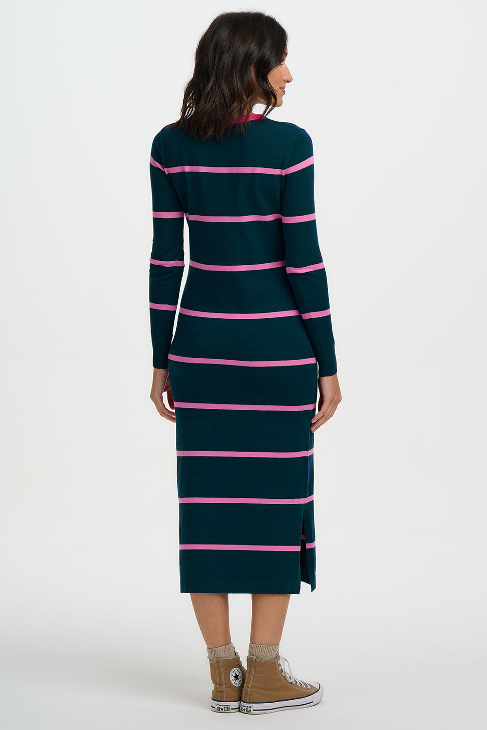 Woman wearing a green and pink striped dress on a white background