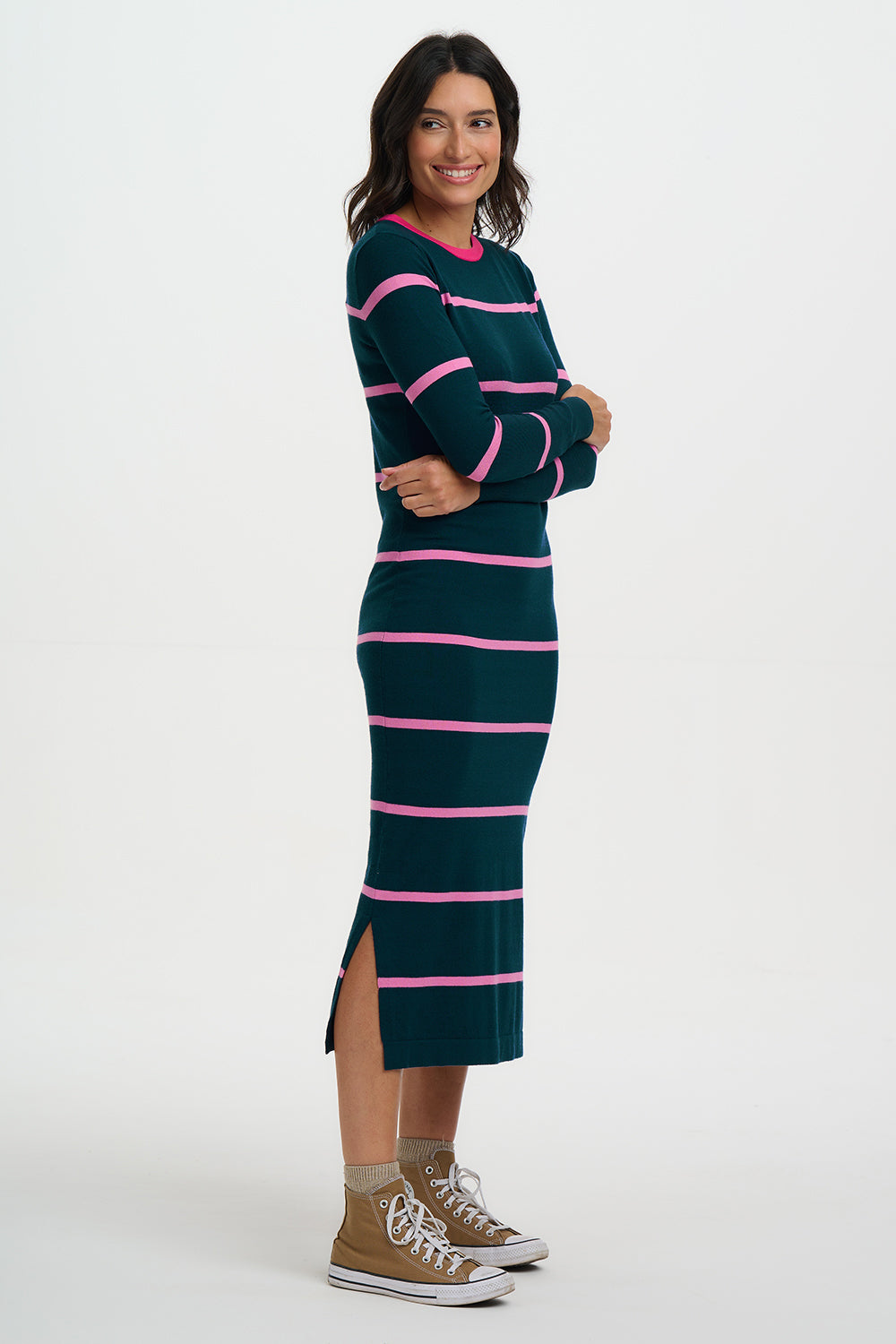 Woman wearing a green and pink striped dress with a white background