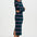 Woman wearing a green and pink striped dress with a white background