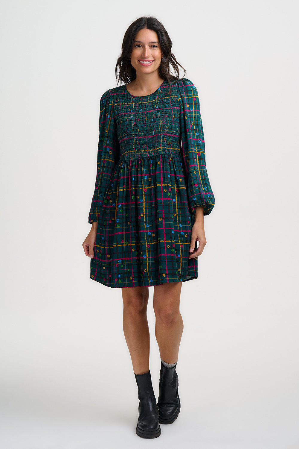 Woman wearing a plaid dress on a white background