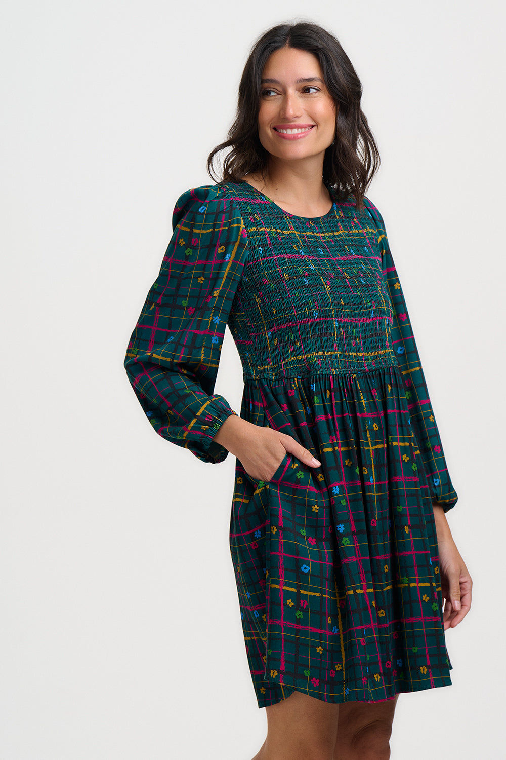Woman wearing a plaid dress with a white background