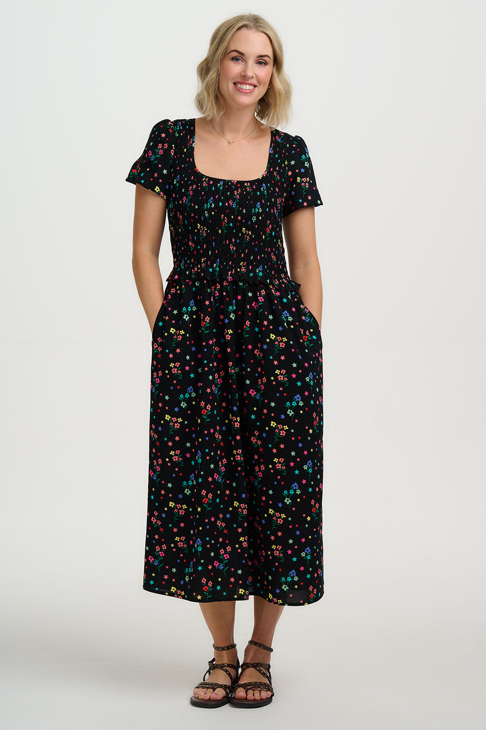 Woman wearing a black floral dress on a white background