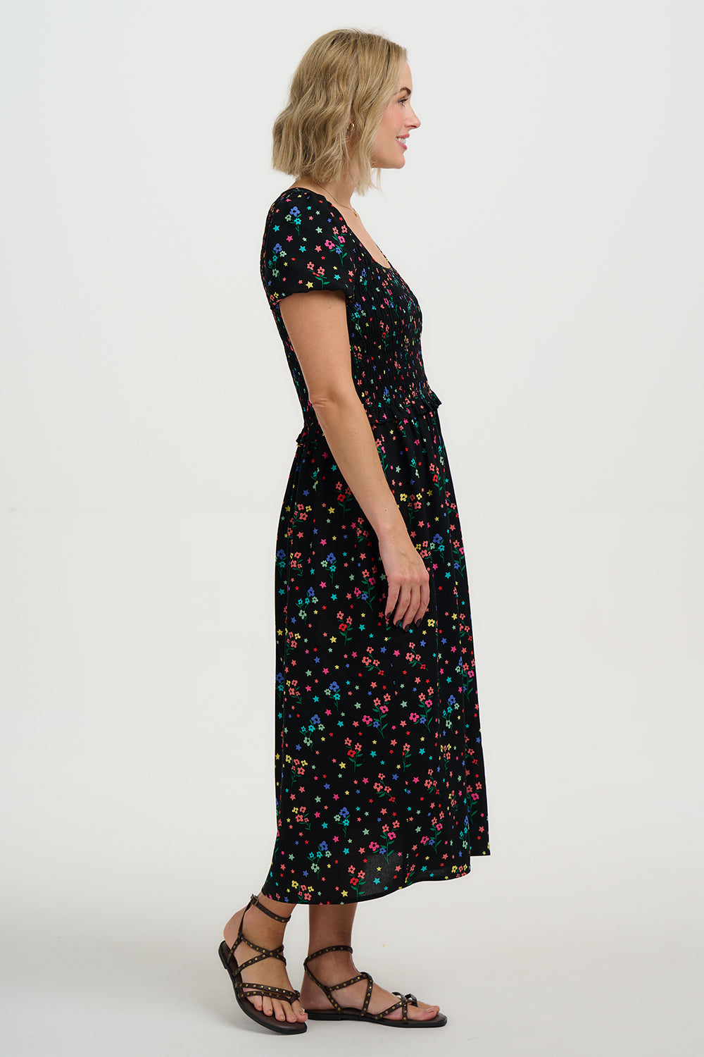 Woman wearing a black floral dress on a white background