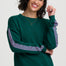 Woman wearing a green sweatshirt with pink stripes on a white background