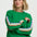 Woman wearing a green sweater with colorful stripes on a white background
