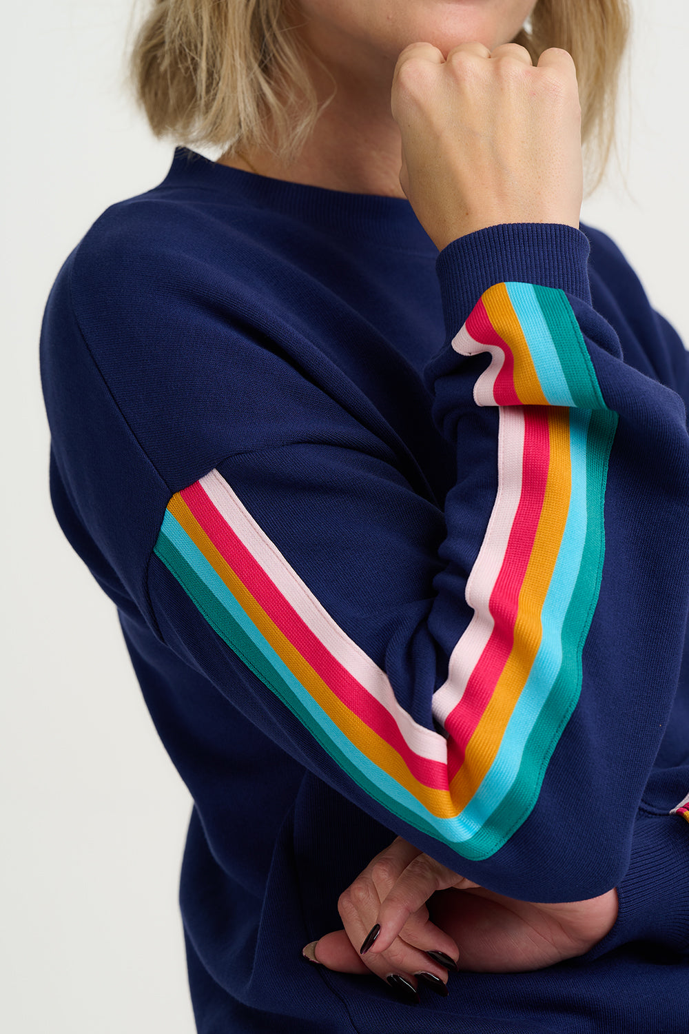 Navy blue sweatshirt with colorful striped sleeves on a white background