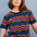 A woman modeling a black and multicolored wavy chevron stripe t-shirt.