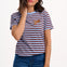Sugarhill Brighton model wearing a striped t-shirt with a small graphic on a white background
