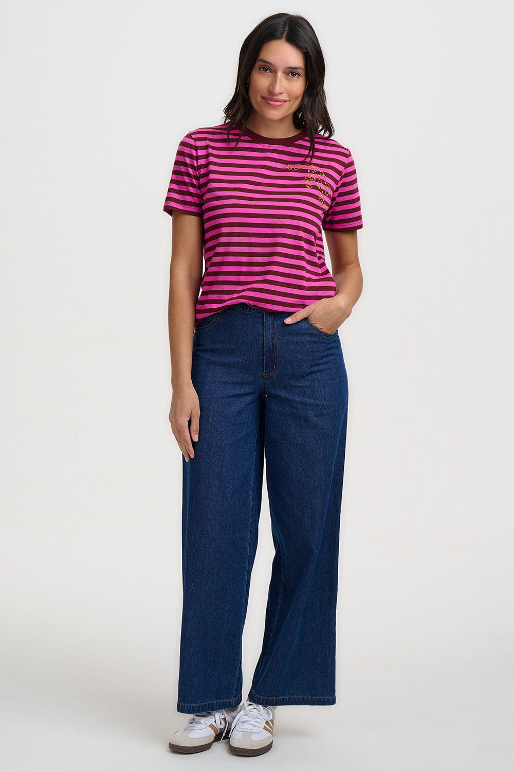 Woman wearing a striped shirt and blue jeans on a white background