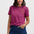 Woman wearing a pink and purple striped t-shirt with a leopard print design on a plain background