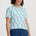 Light blue t-shirt with pink cherry pattern on a white background