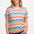 A woman smiling and wearing a multicolored wavy rainbow stripe t-shirt with a crew neck.