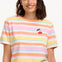 A woman modeling a multicolored striped t-shirt with a small embroidered cherry on the chest, paired with a blue denim skirt.