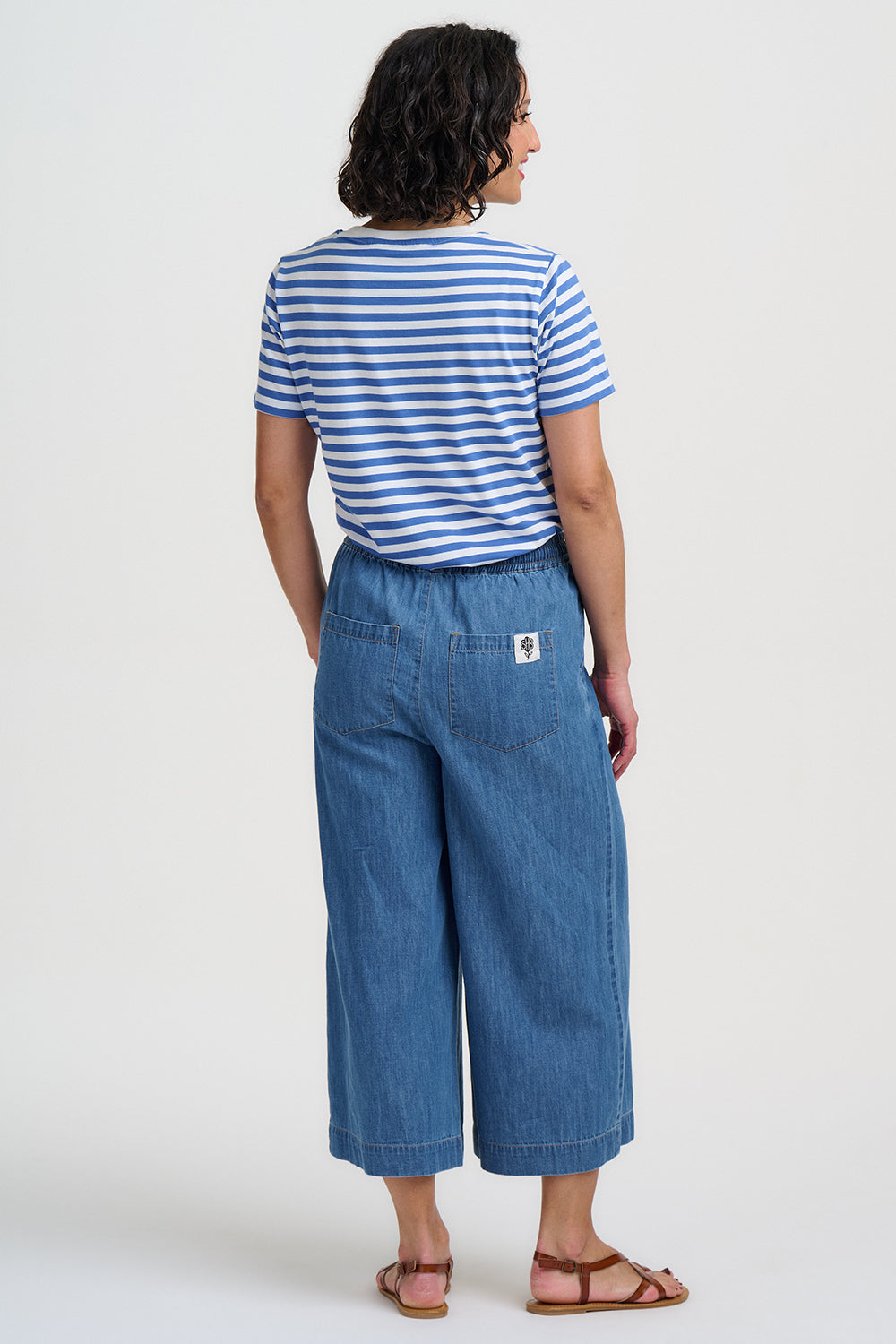 Blue and white striped t-shirt with yellow banana prints on a plain background