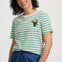 Woman wearing a green and white striped t-shirt with a penguin design on a plain background