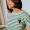 Person wearing a green and white striped t-shirt with a toucan design.