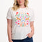 Sugarhill Brighton model  wearing a white t-shirt with floral and animal design on a plain background
