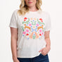Sugarhill Brighton model  wearing a white t-shirt with floral and animal design on a plain background