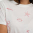 White t-shirt with red embroidered designs on a person wearing it.