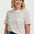 a woman wearing a white tshirt with concenteic circle print 