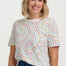 a woman wearing a white tshirt with concenteic circle print 