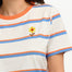 Person wearing a striped shirt with a flower design, standing