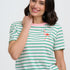Woman wearing a striped shirt and wide-leg jeans on a white background