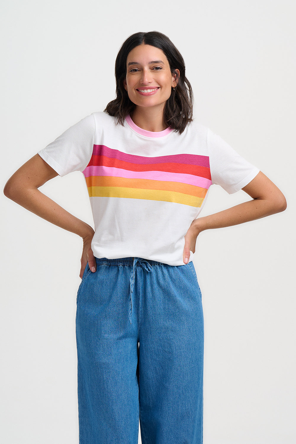 Person wearing a white t-shirt and blue jeans on a white background