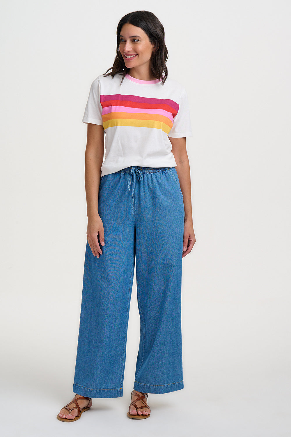 Person wearing a white t-shirt and blue jeans on a white background