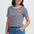 Woman wearing a striped shirt with a small yellow graphic on a plain background